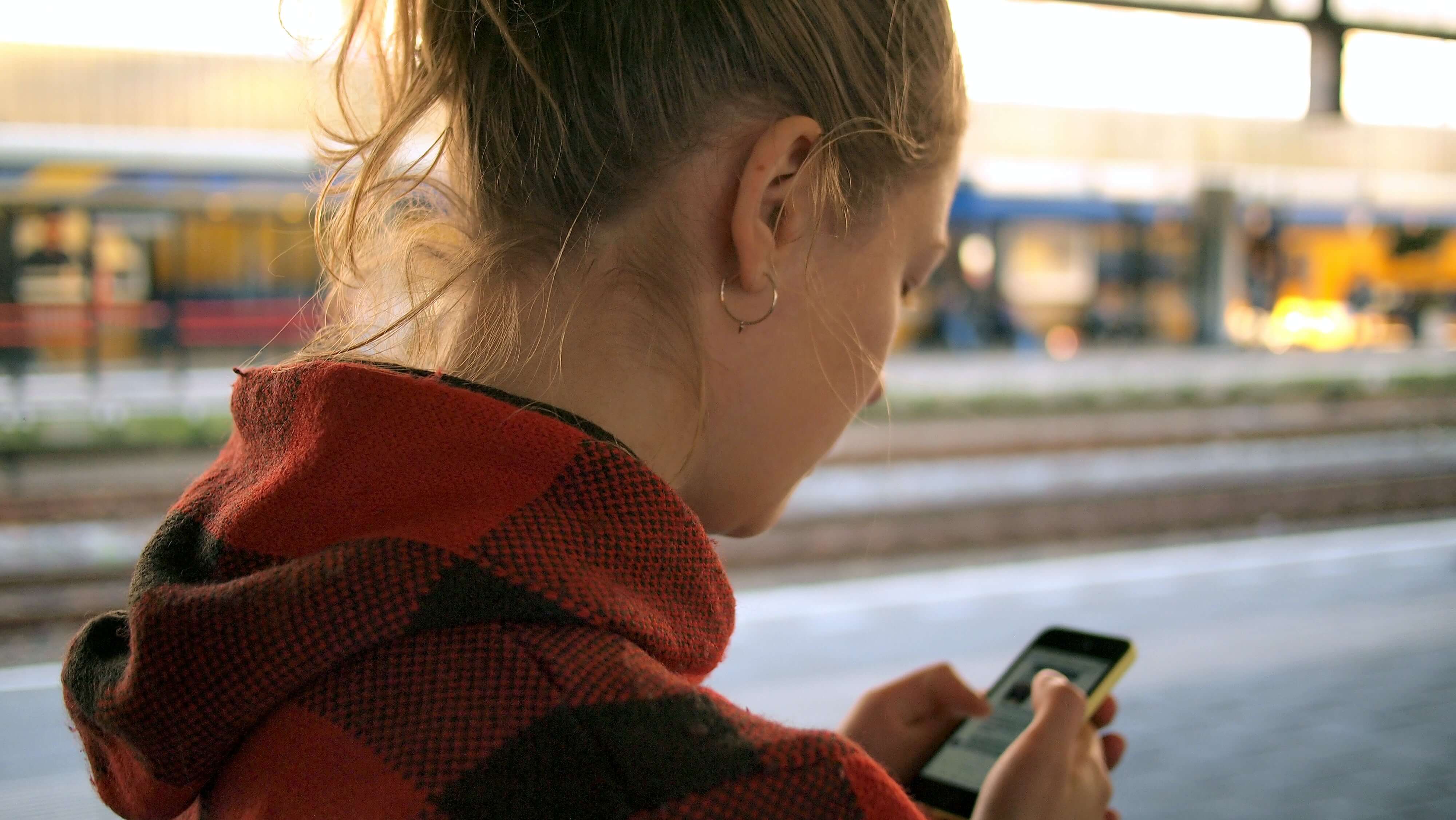 Girl with phone outside browsing-1